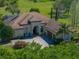Charming home featuring mature landscaping, a tile roof, and a brick driveway at 34201 Kentucky Derby Pl, Dade City, FL 33525