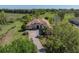 Aerial view of the house featuring a large, well-kept lawn, brick driveway, and mature trees at 34201 Kentucky Derby Pl, Dade City, FL 33525