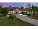 Elegant home exterior featuring lush landscaping, brick driveway, and a neutral color palette at 34201 Kentucky Derby Pl, Dade City, FL 33525