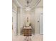 Inviting foyer featuring elegant lighting, tile floors, and a decorative console table with decorative items at 34201 Kentucky Derby Pl, Dade City, FL 33525