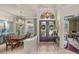 Grand foyer with decorative front door, chandelier, and view into the formal dining room at 34201 Kentucky Derby Pl, Dade City, FL 33525