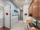 Hallway with desk area, white wainscoting, and access to other rooms at 34201 Kentucky Derby Pl, Dade City, FL 33525