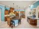 Bright kitchen features an island with seating, custom cabinetry, and stainless steel appliances at 34201 Kentucky Derby Pl, Dade City, FL 33525