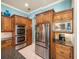 Kitchen features stainless steel microwave, oven, refrigerator, and custom cabinetry at 34201 Kentucky Derby Pl, Dade City, FL 33525