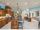Open kitchen with a large island, custom cabinetry, and stainless steel appliances at 34201 Kentucky Derby Pl, Dade City, FL 33525