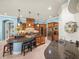 Kitchen boasts a large center island, custom cabinets, granite countertops, and stainless steel appliances at 34201 Kentucky Derby Pl, Dade City, FL 33525