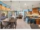 Open-concept living area with tile floors and a view of the kitchen and outdoor living space at 34201 Kentucky Derby Pl, Dade City, FL 33525