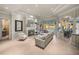 Bright living room featuring a fireplace, neutral palette, and sliding glass doors to the pool at 34201 Kentucky Derby Pl, Dade City, FL 33525