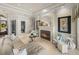 Open concept living room with fireplace and views into the foyer and dining area at 34201 Kentucky Derby Pl, Dade City, FL 33525