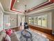 Bright living room boasting hardwood floors, large windows with plantation shutters, and access to the patio at 34201 Kentucky Derby Pl, Dade City, FL 33525