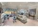Elegant living room with access to the pool area and open views to the kitchen and dining spaces at 34201 Kentucky Derby Pl, Dade City, FL 33525