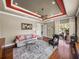 Cozy living room featuring a ceiling fan, hardwood floors, neutral paint, and a large decorative rug at 34201 Kentucky Derby Pl, Dade City, FL 33525
