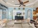 Open floor plan with a TV, ceiling fan, and built-in cabinets in the living room at 34201 Kentucky Derby Pl, Dade City, FL 33525