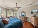 Bright and spacious main bedroom with hardwood floors, and abundant natural light from multiple windows at 34201 Kentucky Derby Pl, Dade City, FL 33525