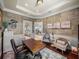 Spacious office showcasing hardwood floors, decor, built-in cabinets, and an open view to the living areas at 34201 Kentucky Derby Pl, Dade City, FL 33525
