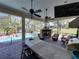 View of outdoor bar with granite countertop, ceiling fans and view of backyard at 34201 Kentucky Derby Pl, Dade City, FL 33525