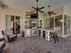 This is the outdoor kitchen with a grill, mini-fridge, wet bar, and barstool seating at 34201 Kentucky Derby Pl, Dade City, FL 33525
