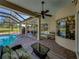 Inviting covered outdoor living space with a private pool and comfortable lounge seating at 34201 Kentucky Derby Pl, Dade City, FL 33525