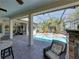Stunning outdoor patio area with in-ground pool, mature landscaping, and comfortable seating at 34201 Kentucky Derby Pl, Dade City, FL 33525
