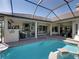 View of the stunning pool and patio area complete with an outdoor kitchen at 34201 Kentucky Derby Pl, Dade City, FL 33525
