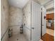 Spacious tiled shower with a built-in shelf and a glass door adjacent to a room with a built-in desk and cabinets at 34201 Kentucky Derby Pl, Dade City, FL 33525