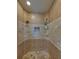 Walk-in shower with dual showerheads and tiled walls at 34201 Kentucky Derby Pl, Dade City, FL 33525