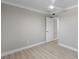 Neutral bedroom with a ceiling fan, new light fixture, and light wood flooring at 4362 Wesley Ln, North Port, FL 34287