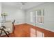 Well-lit bedroom featuring wood floors, a ceiling fan, and a large window at 5117 Brynn Mawr Dr, Tampa, FL 33624