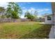 Spacious backyard with lush lawn and wooden fence offers privacy and room for outdoor activities at 5261 43Rd N Ave, St Petersburg, FL 33709