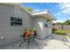 Back of house featuring neutral paint, a patio and exterior door to the house, plus a garden table at 5261 43Rd N Ave, St Petersburg, FL 33709