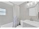 Updated bathroom with shower-tub combo, white shower curtain, tiled walls and vanity with sink at 5261 43Rd N Ave, St Petersburg, FL 33709