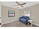 Bright bedroom with hardwood floors, neutral paint, a ceiling fan, and natural light from two windows at 5261 43Rd N Ave, St Petersburg, FL 33709