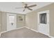 Bright bedroom featuring wood-look floors, a ceiling fan, a window and an exterior door at 5261 43Rd N Ave, St Petersburg, FL 33709