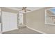 Bedroom featuring neutral paint, wood-look floors, a window with blinds and an adjacent closet at 5261 43Rd N Ave, St Petersburg, FL 33709
