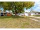 Charming single-story home with a well-maintained lawn and driveway, complemented by a large shade tree at 5261 43Rd N Ave, St Petersburg, FL 33709