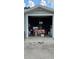 This is a view of a garage with a large open door. The garage contains a large number of items at 5261 43Rd N Ave, St Petersburg, FL 33709
