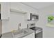 Modern kitchen features stainless steel appliances, white cabinets, subway tile backsplash, and durable countertops at 5261 43Rd N Ave, St Petersburg, FL 33709