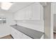 Kitchen boasts ample counter space, white cabinets, subway tile backsplash, and modern lighting at 5261 43Rd N Ave, St Petersburg, FL 33709