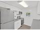 Bright kitchen with white cabinets, stainless steel appliances, subway tile backsplash, and wood-look floors at 5261 43Rd N Ave, St Petersburg, FL 33709