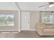 Inviting living room featuring modern flooring, neutral paint, and ample natural light from nearby windows at 5261 43Rd N Ave, St Petersburg, FL 33709