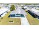 Aerial view of a cozy mobile home featuring a covered carport and well-kept surroundings in a serene neighborhood at 5306 Mary St, Zephyrhills, FL 33542