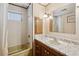 Bathroom features a vanity with marble countertop and tub with shower at 5306 Mary St, Zephyrhills, FL 33542