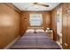 Comfortable bedroom with bed, ceiling fan, and an attached bathroom at 5306 Mary St, Zephyrhills, FL 33542