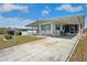Cozy mobile home with a covered porch and ample parking space, ideal for comfortable living in a tranquil environment at 5306 Mary St, Zephyrhills, FL 33542