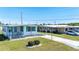 Home with a well-manicured lawn and long carport at 5306 Mary St, Zephyrhills, FL 33542