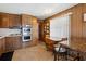 Traditional kitchen with wood cabinets, stainless steel appliances, and a cozy dining area with natural light at 5306 Mary St, Zephyrhills, FL 33542