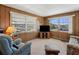 Comfortable living room with plush seating, neutral carpet, and lots of light from the surrounding windows at 5306 Mary St, Zephyrhills, FL 33542