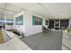 Relaxing covered porch area of a mobile home, perfect for outdoor seating and enjoying the serene neighborhood at 5306 Mary St, Zephyrhills, FL 33542