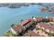 Aerial view of waterfront condos with well-maintained landscaping and ample parking spaces near the bay at 553 Haven Point Dr, Treasure Island, FL 33706