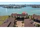 A beautiful aerial view of condos with water views and palm trees at 553 Haven Point Dr, Treasure Island, FL 33706